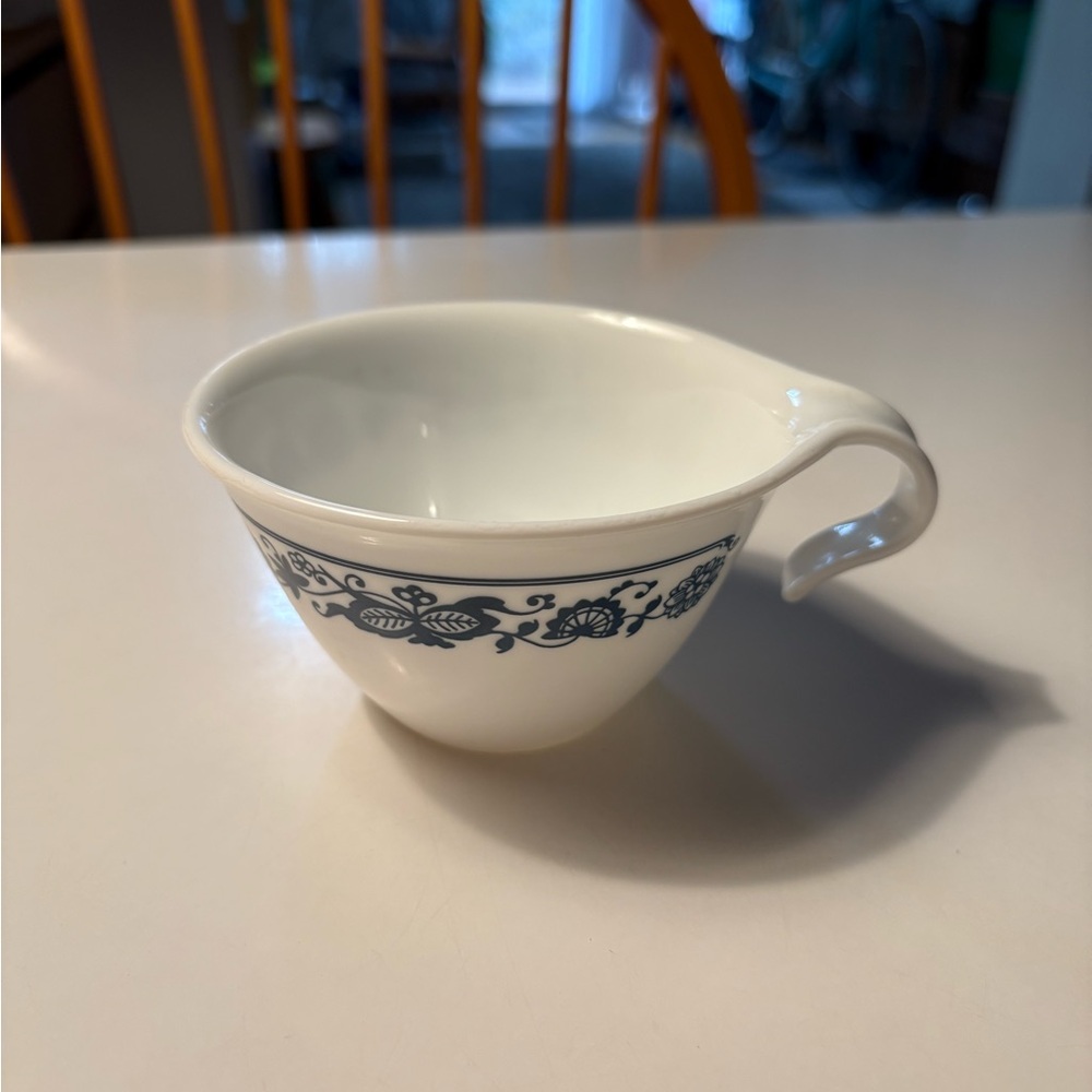 White Teacup with Blue Floral Design